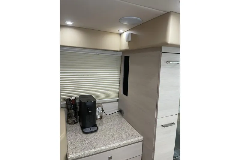 Slide: The Image of 2008 Sea Ray 47 Sedan Bridge interior with coffee maker on countertop. - 16