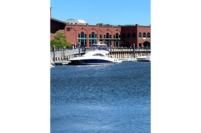 Slide: The Image of 2008 Sea Ray 47 Sedan Bridge yacht docked by brick building. - 18