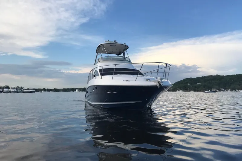 Slide: The Image of 2008 Sea Ray 47 Sedan Bridge yacht on calm water under a blue sky. - 6