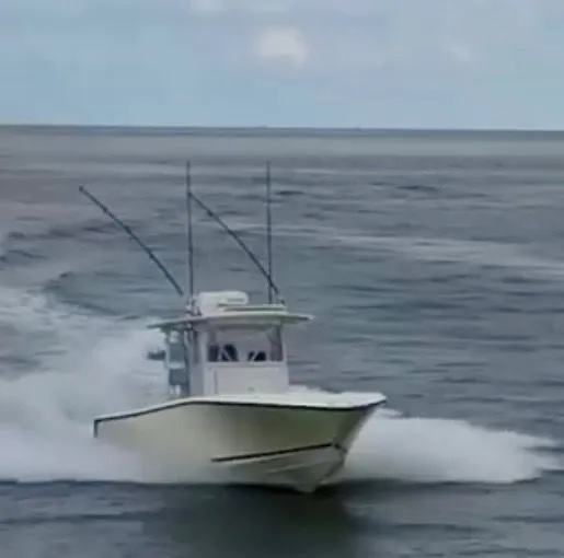 Slide: The Image of 2000 SeaVee 340i boat cruising on open water. - 1