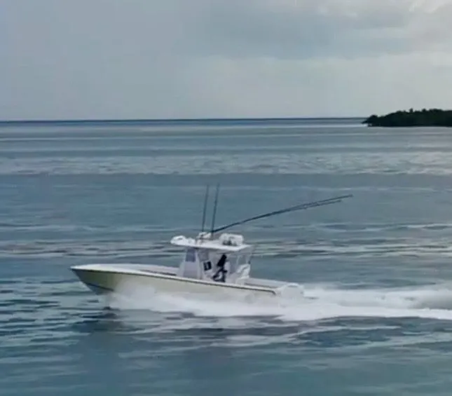 Slide: The Image of 2000 SeaVee 340i boat cruising on the ocean. - 10