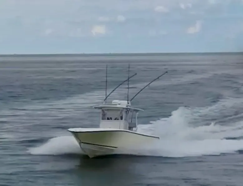 Slide: The Image of 2000 SeaVee 340i boat cruising on open sea. - 2