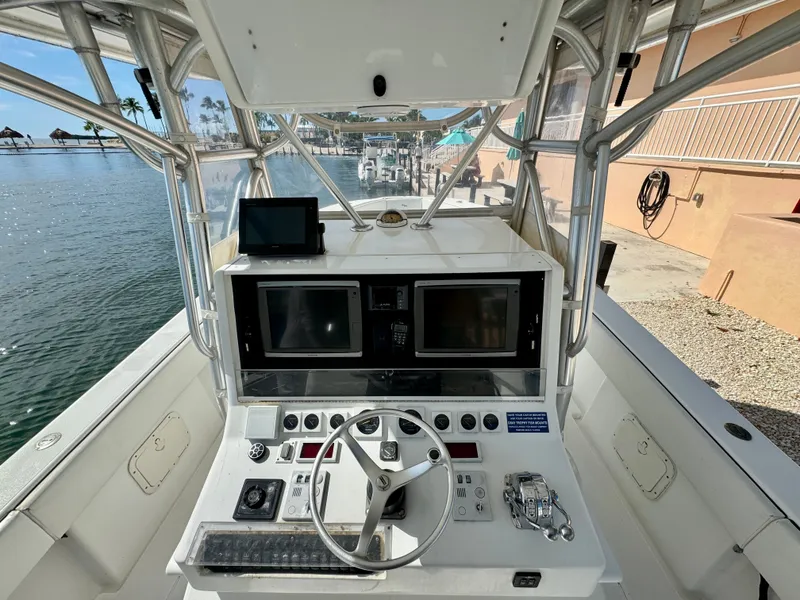 Slide: The Image of 2000 SeaVee 340i helm with modern electronics and steering wheel. - 23