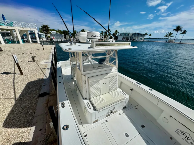 Slide: The Image of 2000 SeaVee 340i boat docked with fishing rods. - 24