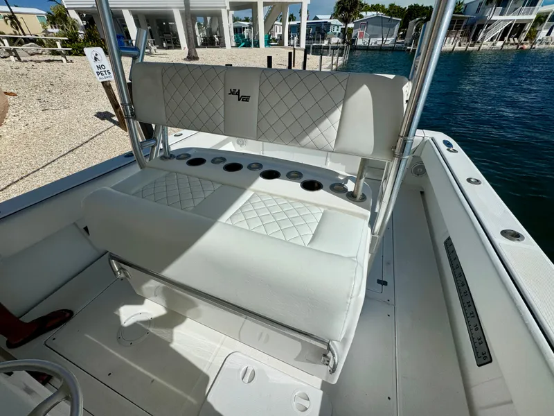 Slide: The Image of Interior of a 2000 SeaVee 340i boat with white seating. - 25