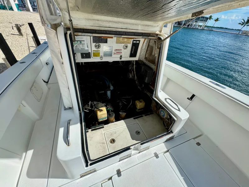 Slide: The Image of Engine compartment of a 2000 SeaVee 340i boat by the water. - 28