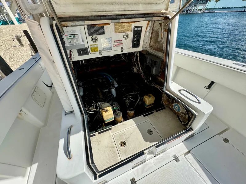 Slide: The Image of Engine compartment of a 2000 SeaVee 340i boat by the water. - 29