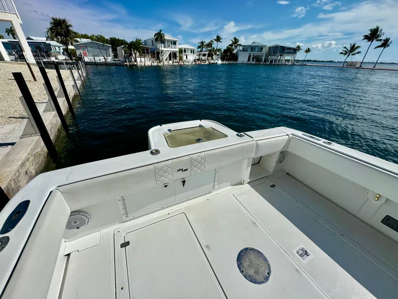 Slide: The Image of 2000 SeaVee 340i boat on water with palm trees in background. - 31
