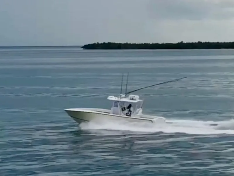 Slide: The Image of 2000 SeaVee 340i boat speeding across the ocean. - 4