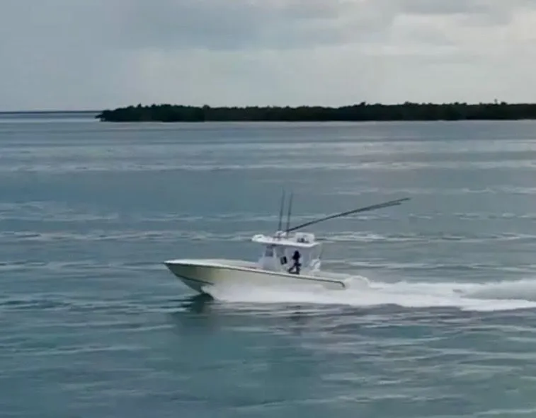 Slide: The Image of SeaVee 340i boat from 2000 cruising on calm waters. - 7