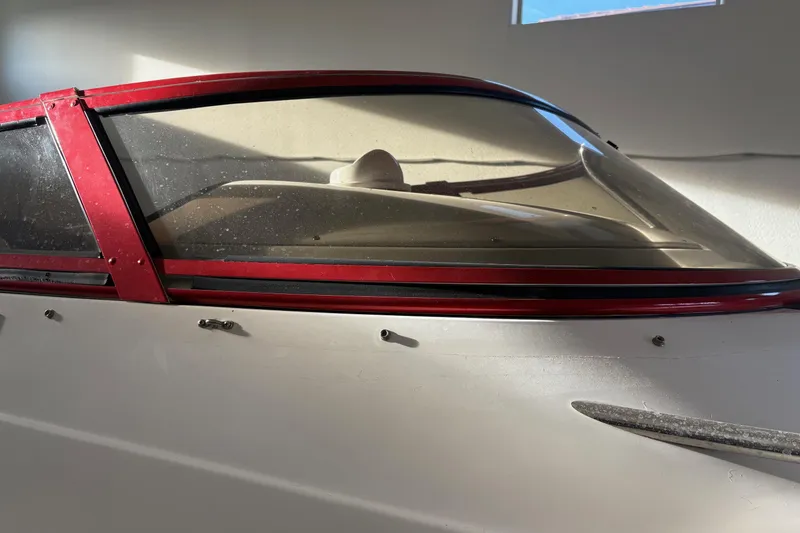 Slide: The Image of 2006 Fountain 42 Lightning boat with red trim and windshield in a garage. - 10