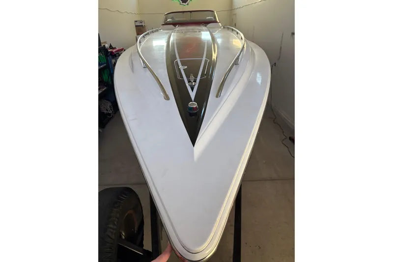 Slide: The Image of 2006 Fountain 42 Lightning boat, sleek white hull, stored indoors. - 11