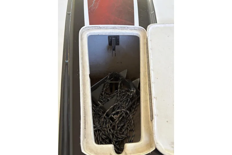 Slide: The Image of Open storage compartment on 2006 Fountain 42 Lightning boat with rope and anchor inside. - 12