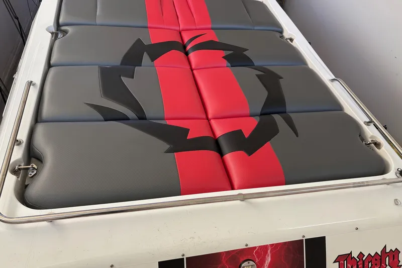 Slide: The Image of 2006 Fountain 42 Lightning boat seat with red and gray design, featuring a bold graphic. - 14