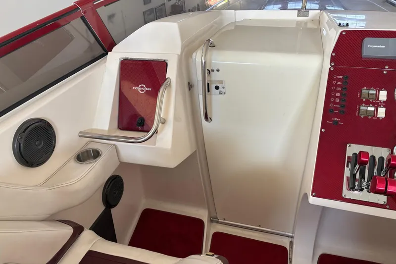 Slide: The Image of Interior of a 2006 Fountain 42 Lightning boat with red accents and control panel. - 26