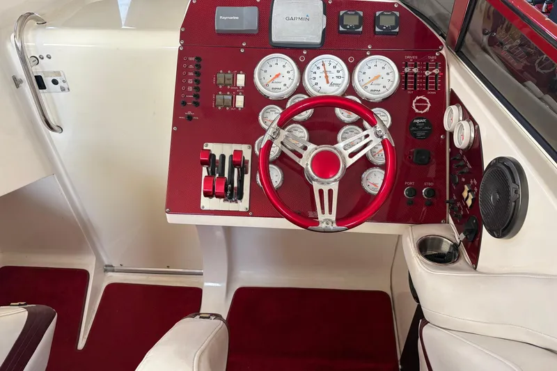 Slide: The Image of 2006 Fountain 42 Lightning boat dashboard with red accents and steering wheel. - 27