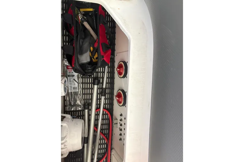 Slide: The Image of Storage compartment of 2006 Fountain 42 Lightning boat with tools and equipment. - 28