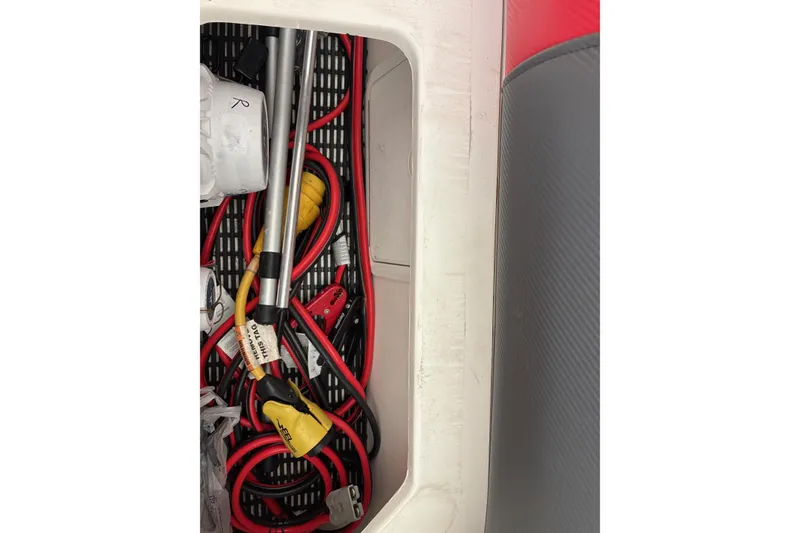 Slide: The Image of Storage compartment of a 2006 Fountain 42 Lightning boat with cables and tools. - 29