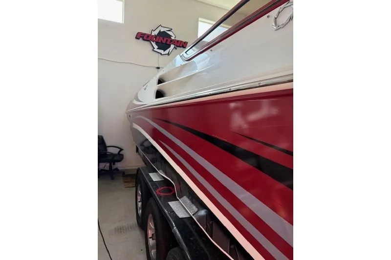 Slide: The Image of 2006 Fountain 42 Lightning boat with red and white design in a garage. - 3