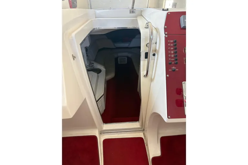 Slide: The Image of Interior cabin view of a 2006 Fountain 42 Lightning boat with red carpet and control panel. - 39