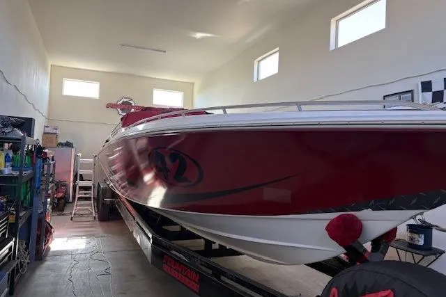 Slide: The Image of 2006 Fountain 42 Lightning speedboat in a garage, red and white design. - 4