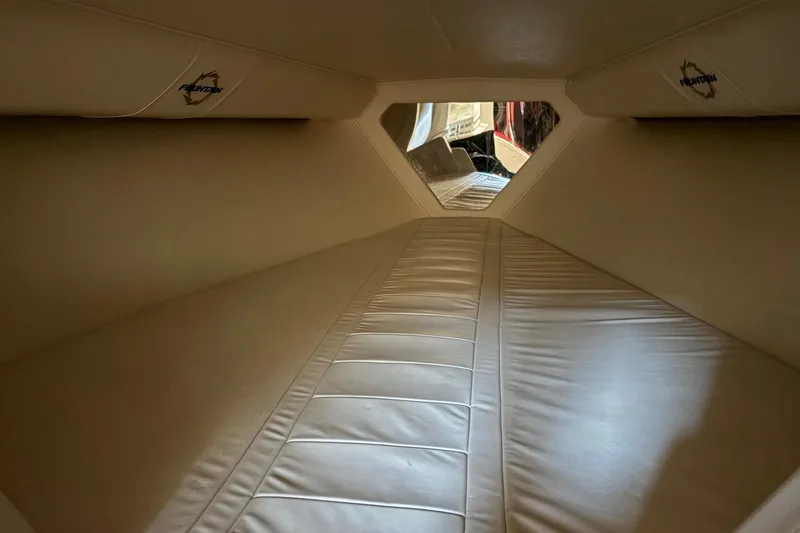 Slide: The Image of Interior cabin of a 2006 Fountain 42 Lightning boat, featuring beige upholstery. - 44