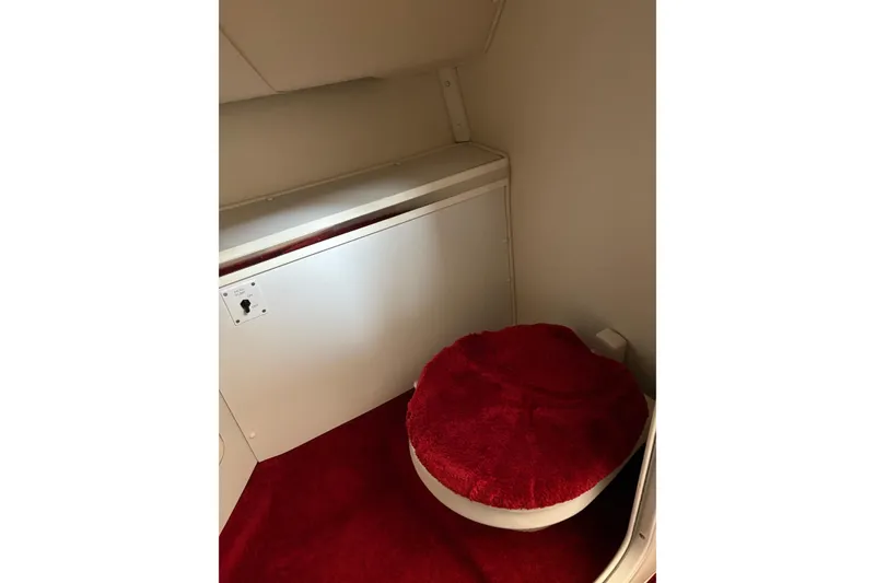 Slide: The Image of 2006 Fountain 42 Lightning boat interior with red carpeted toilet area. - 46