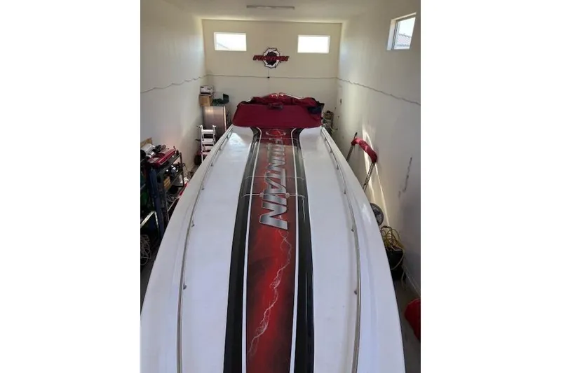 Slide: The Image of 2006 Fountain 42 Lightning boat in garage, top view with red and black design. - 5