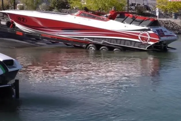 Slide: The Image of Red and white 2006 Fountain 42 Lightning speedboat being launched into the water. - 50