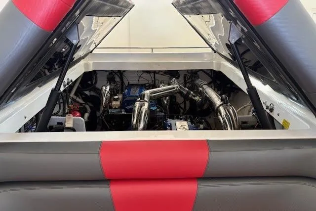 Slide: The Image of Engine compartment of a 2006 Fountain 42 Lightning boat with red and gray upholstery. - 7