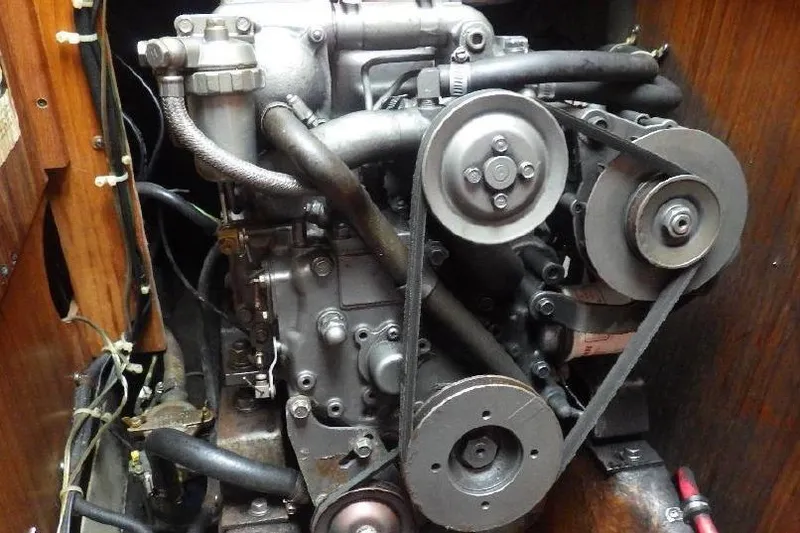 Slide: The Image of 1986 Pearson 303 engine compartment with visible belts and components. - 14