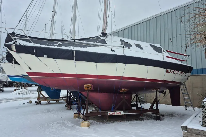 Slide: The Image of 1986 Pearson 303 sailboat, "Bloody Mary," in snowy boatyard storage. - 15