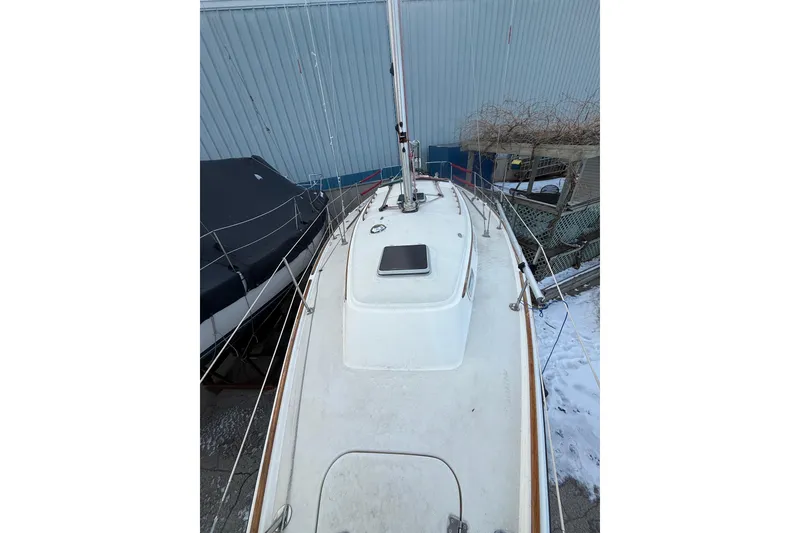 Slide: The Image of 1986 Pearson 303 sailboat deck view, docked with snow on the ground. - 5