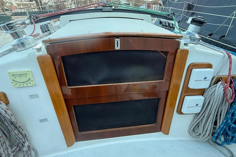 Slide: The Image of Cockpit of 1986 Pearson 303 sailboat with wooden hatch and nautical equipment. - 7