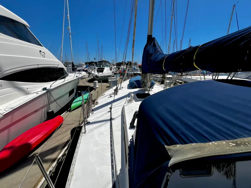 Slide: The Image of 1981 Cheoy Lee Golden Wave yacht docked at marina, surrounded by other boats. - 10