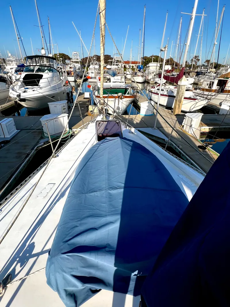 Slide: The Image of 1981 Cheoy Lee Golden Wave yacht docked in a busy marina under clear blue skies. - 12