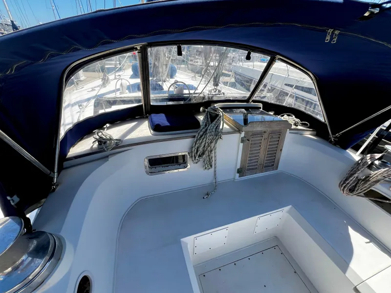 Slide: The Image of 1981 Cheoy Lee Golden Wave yacht cockpit with blue canopy and ropes. - 17
