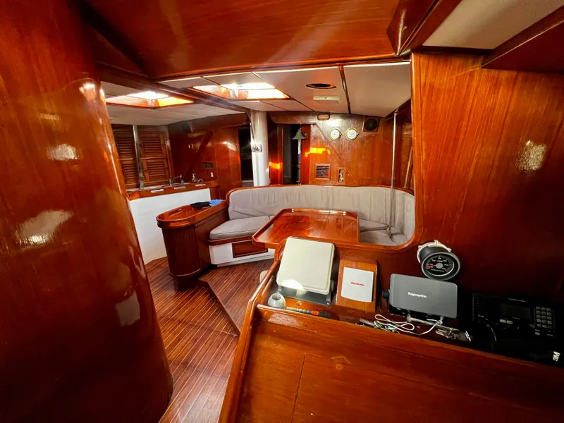 Slide: The Image of 1981 Cheoy Lee Golden Wave yacht interior with wooden finish and cozy seating area. - 18
