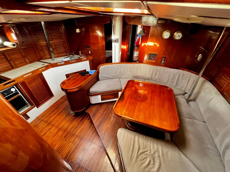 Slide: The Image of Luxurious 1981 Cheoy Lee Golden Wave yacht interior with wood finishes and cozy seating area. - 19