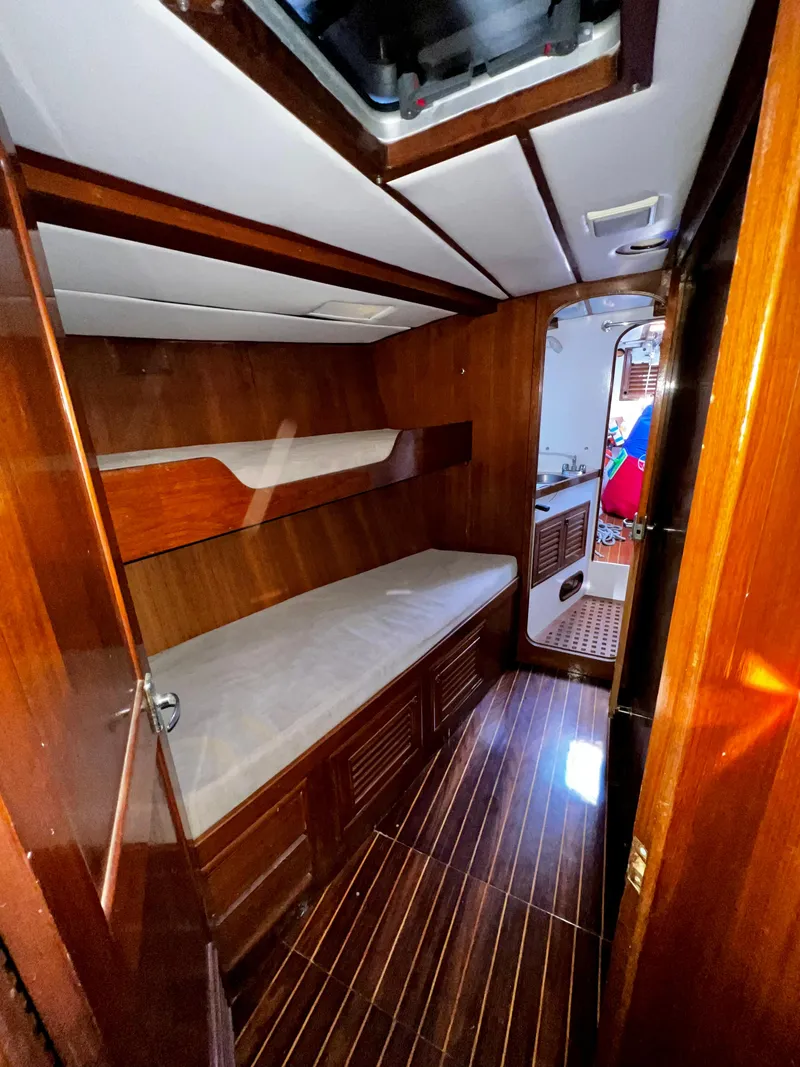Slide: The Image of 1981 Cheoy Lee Golden Wave cabin with wooden interior and bunk beds. - 23