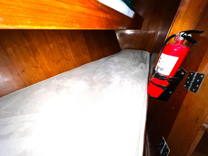 Slide: The Image of 1981 Cheoy Lee Golden Wave cabin interior with wooden finish and mounted fire extinguisher. - 36