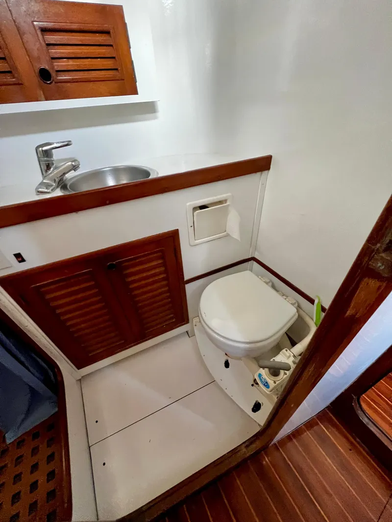 Slide: The Image of 1981 Cheoy Lee Golden Wave yacht bathroom with wooden cabinets and compact fixtures. - 38