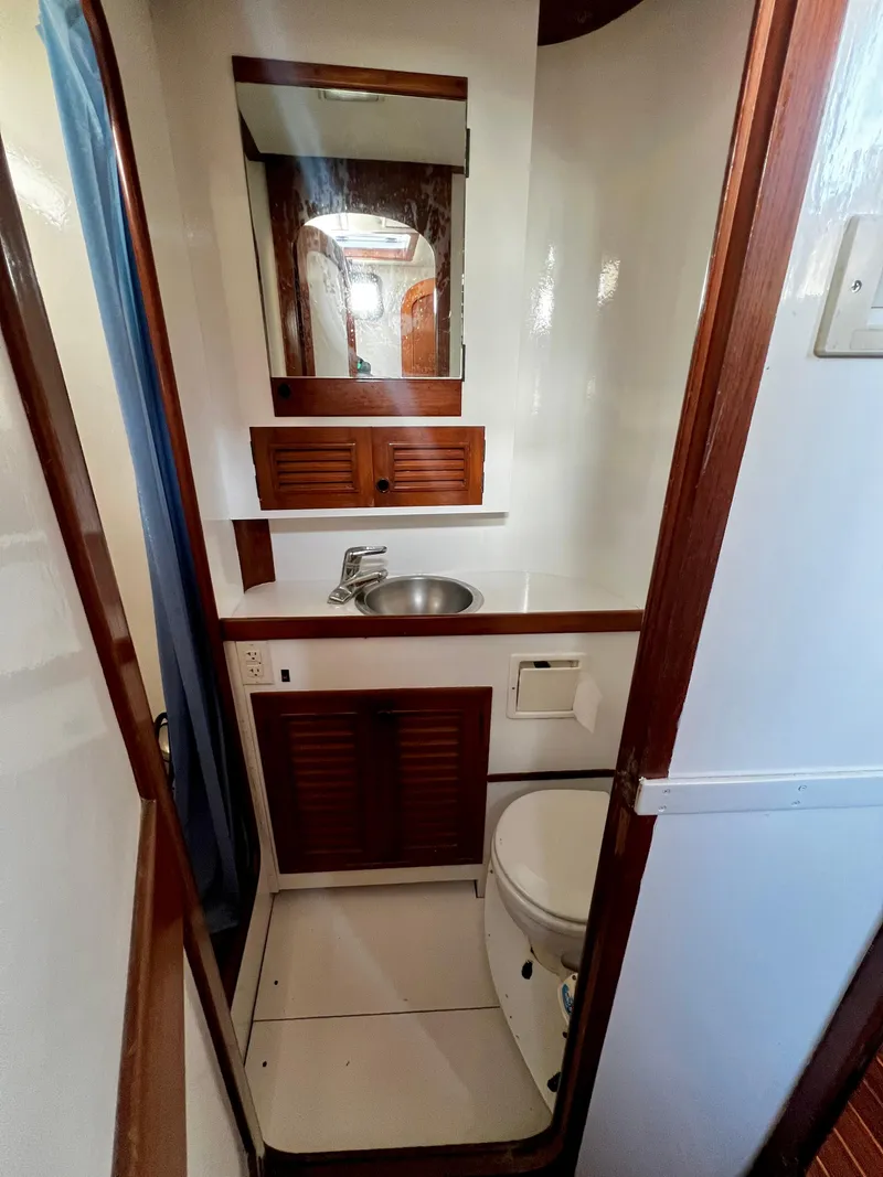 Slide: The Image of 1981 Cheoy Lee Golden Wave yacht bathroom with sink, mirror, and toilet. - 39