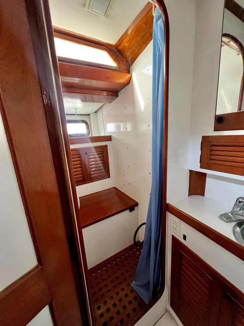 Slide: The Image of 1981 Cheoy Lee Golden Wave yacht interior with wooden cabinetry and blue curtain. - 40