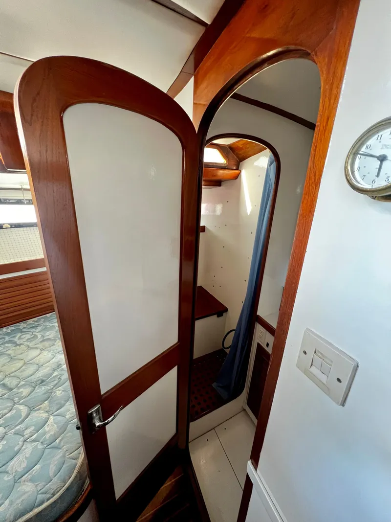 Slide: The Image of Interior of 1981 Cheoy Lee Golden Wave yacht with wooden doors and cozy cabin space. - 41