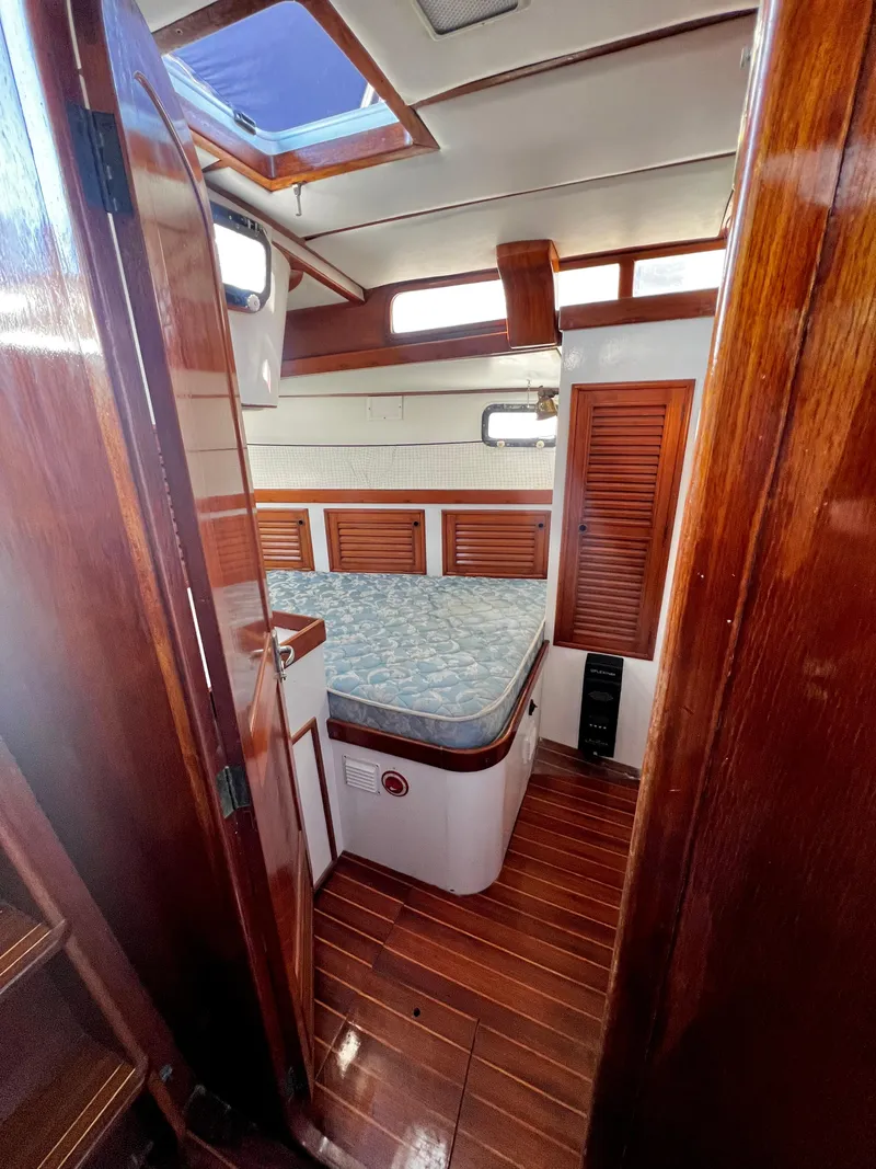 Slide: The Image of 1981 Cheoy Lee Golden Wave cabin interior with wooden finishes and cozy bed. - 43
