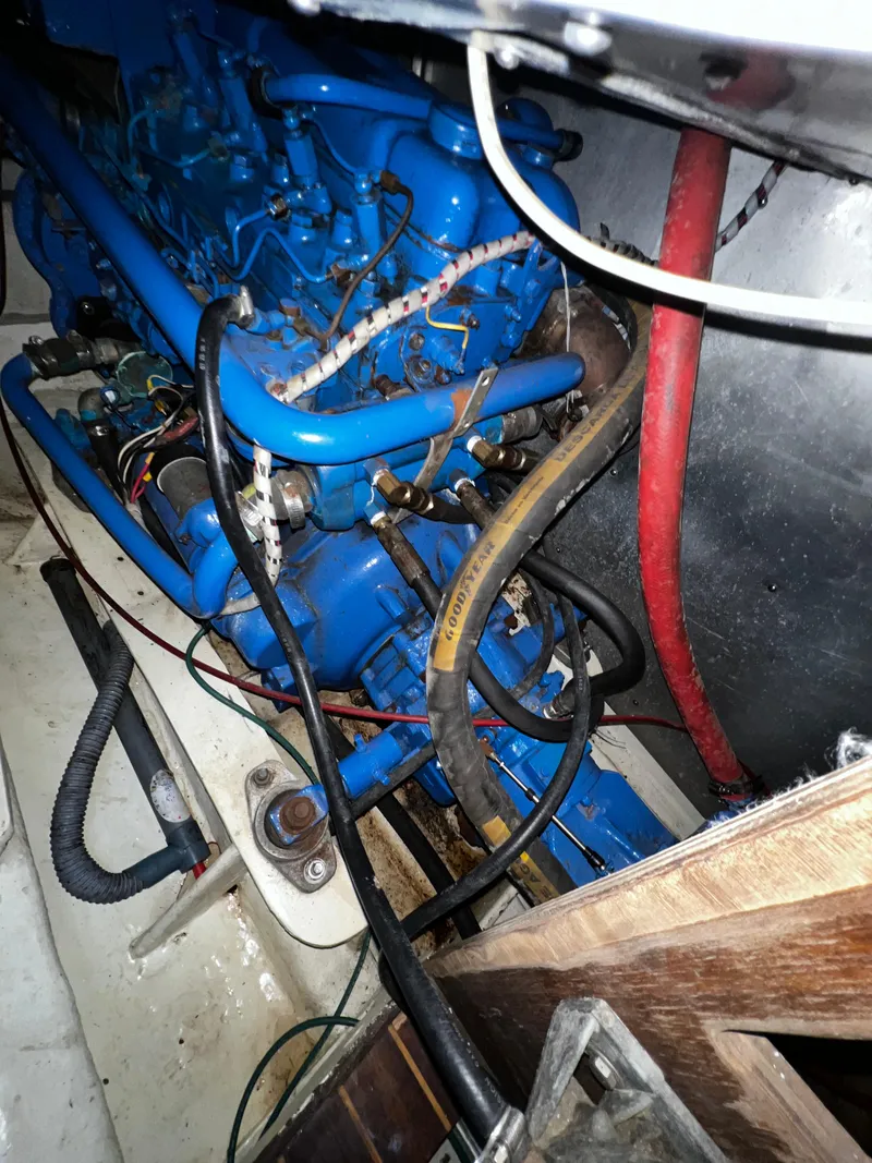 Slide: The Image of Engine compartment of 1981 Cheoy Lee Golden Wave yacht, featuring blue engine and wiring. - 47
