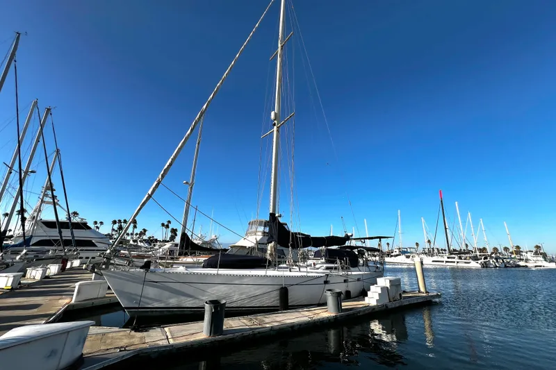 Slide: The Image of 1981 Cheoy Lee Golden Wave sailboat docked in a sunny marina. - 49