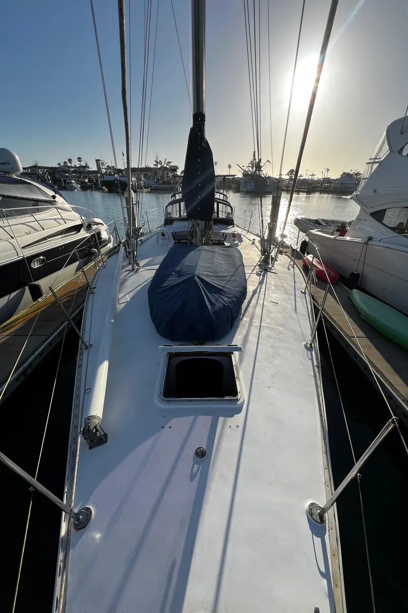 Slide: The Image of 1981 Cheoy Lee Golden Wave sailboat docked at marina, sunlit deck view. - 5