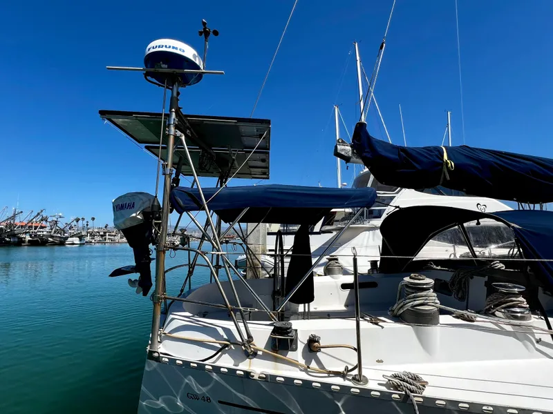 Slide: The Image of 1981 Cheoy Lee Golden Wave yacht docked in a marina under clear blue skies. - 7